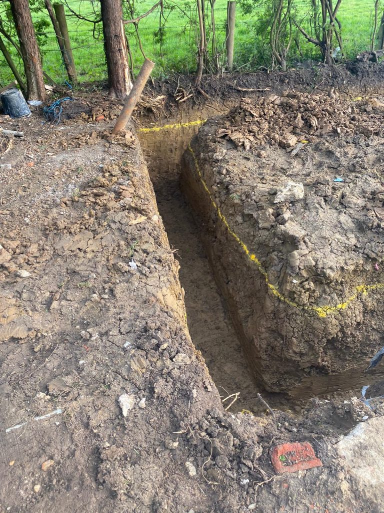 groundworks digging a foundation for a wall