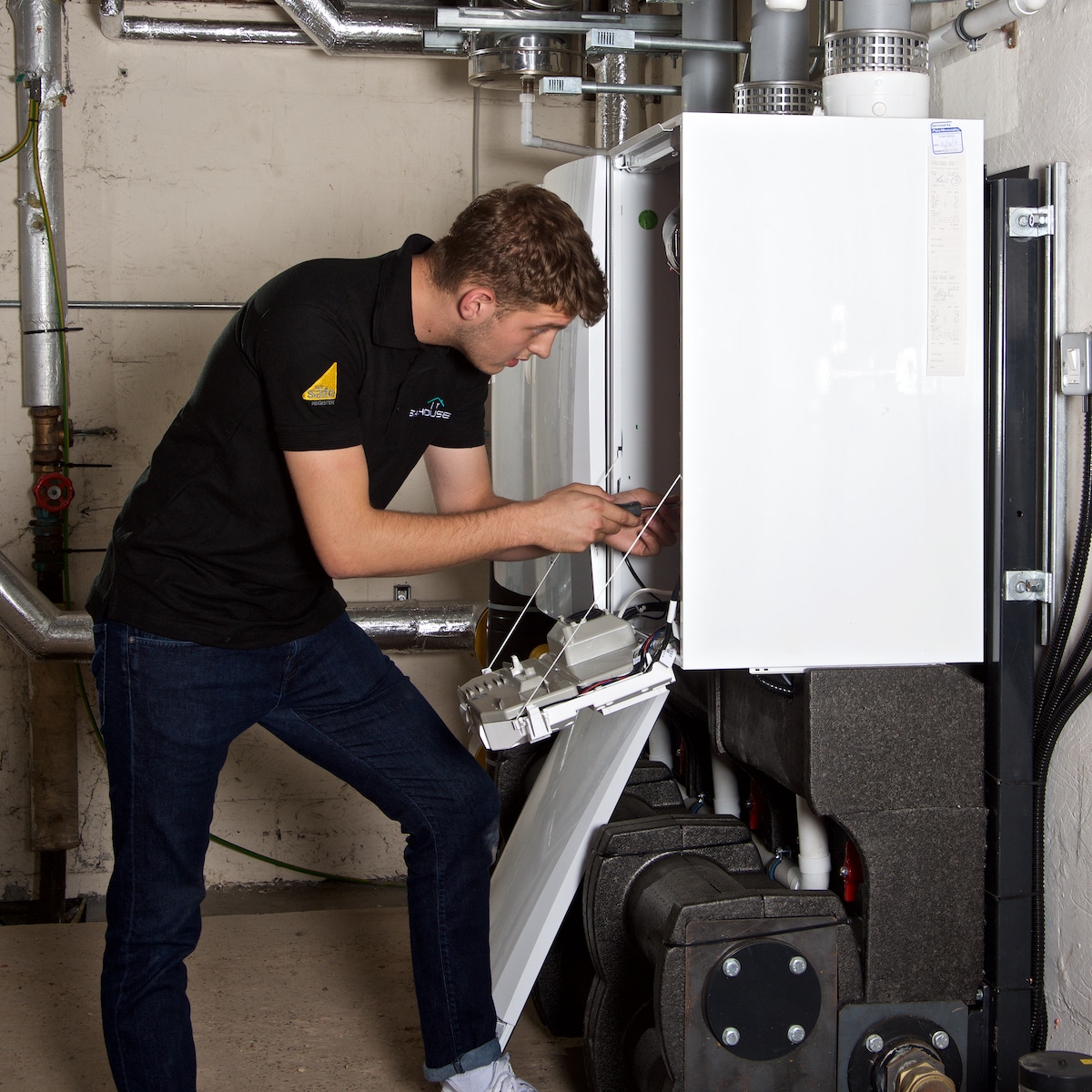 gas fitter working on a boiler